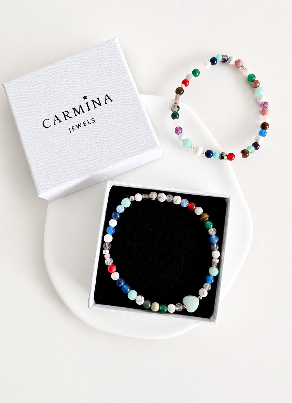 Featuring a glorious mix of vibrant semi precious beads, this beautiful bracelet is designed to add a touch of colour and elegance to any outfit. Choose between a charming Amazonite heart bead or an elegant baroque freshwater pearl as the centre.