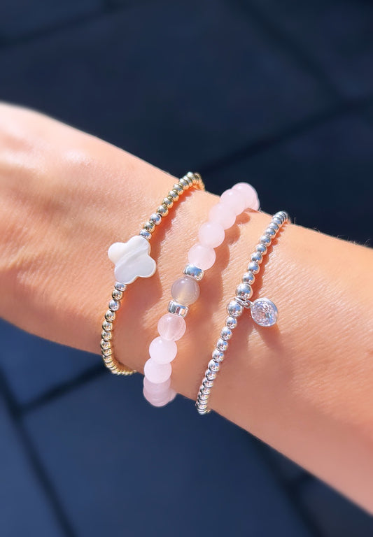 rose quartz gemstone beaded bracelet with silver-colored spacer beads.