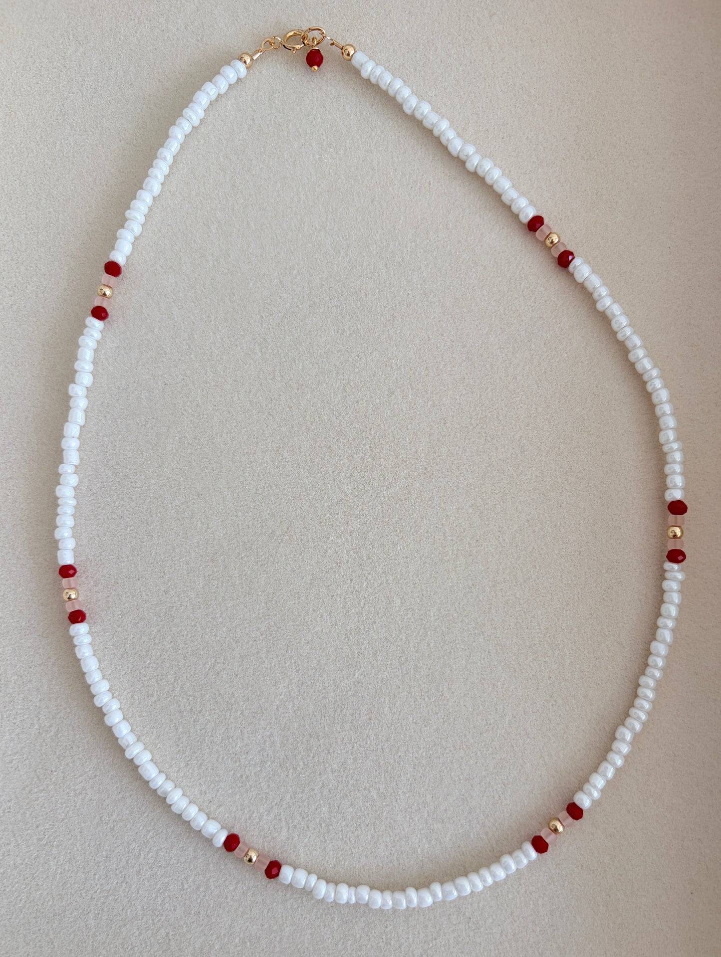 Pretty lustred glass seed bead Necklace, mixed with a subtle pattern of either aqua & pale grey or red/pink crystal glass beads and gold/silver spacer beads. The necklace will be finished with a Gold Filled or Sterling Silver fastening lobster clasp. A perfect necklace for layering with other chains or pendants.
