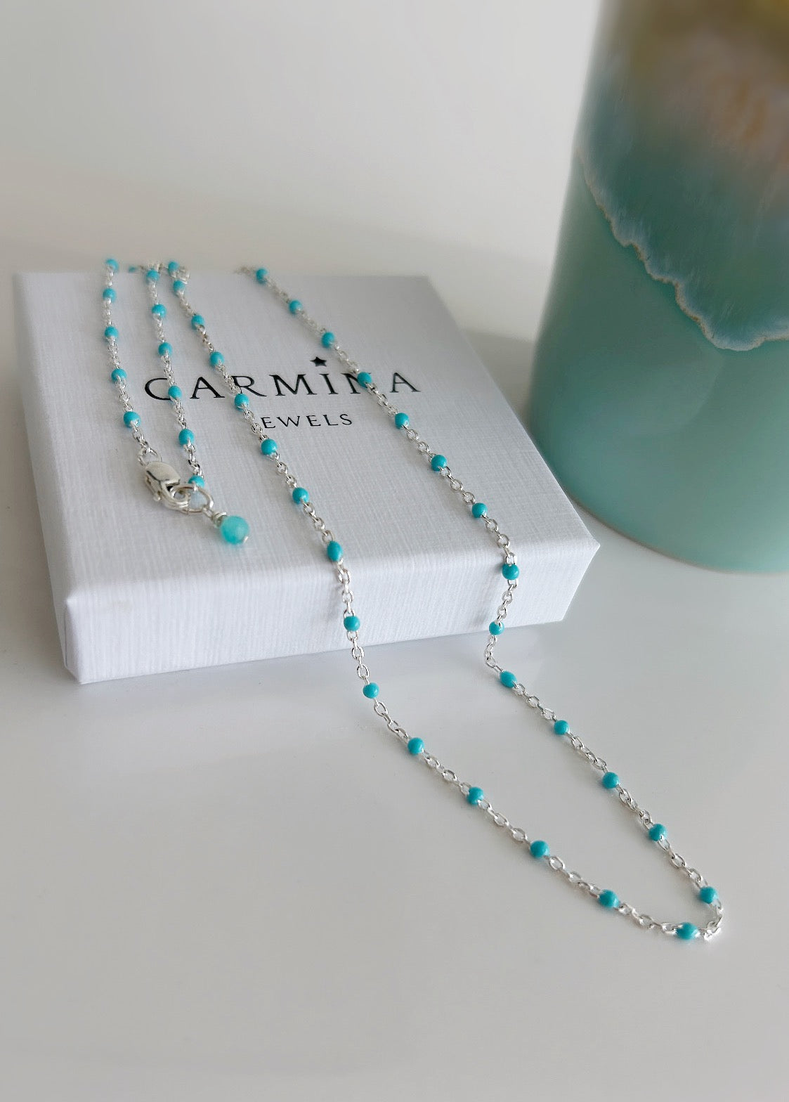 A delicate Gold filled or Sterling Silver flat cable chain necklace dotted with turquoise enamel beads, and finished off with a tiny Amazonite crystal bead at the clasp. 