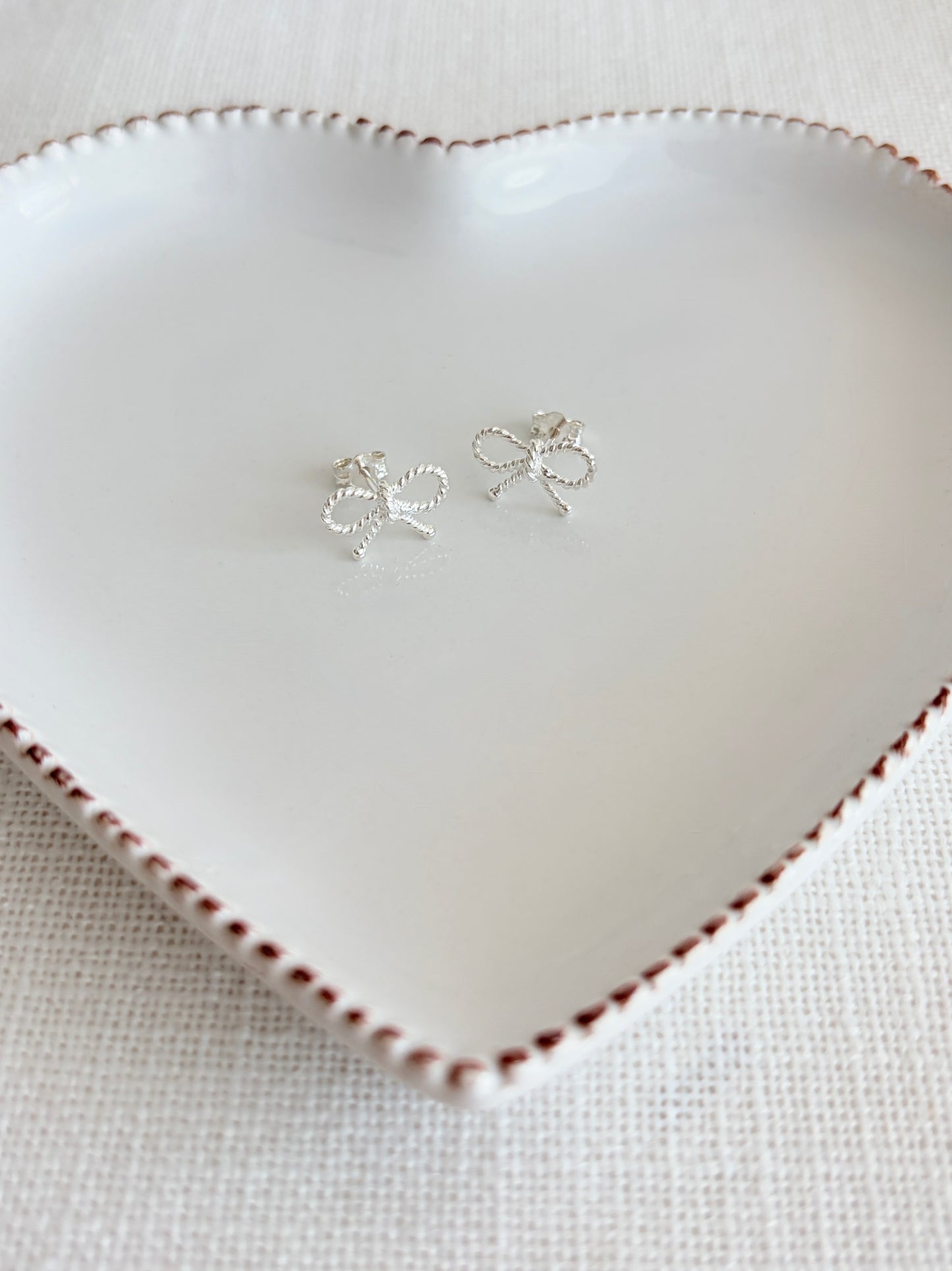 These beautiful bow design ear studs have a tiny bead style detail which catch the light and sparkle so would be perfect day or evening wear.

The earrings measure 12x8mm.