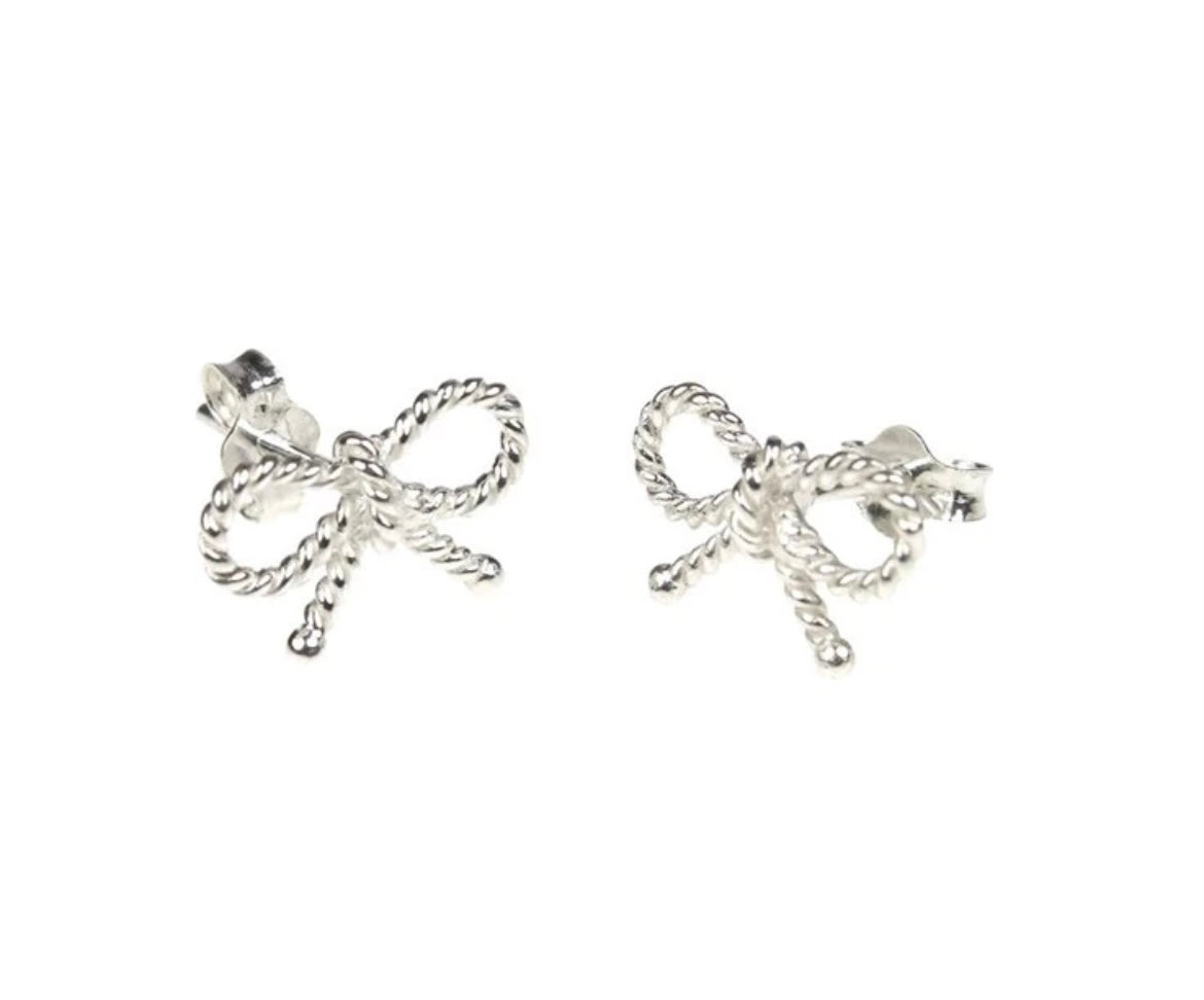 A pair of silver bow stud earrings with a tiny bead style detail.
