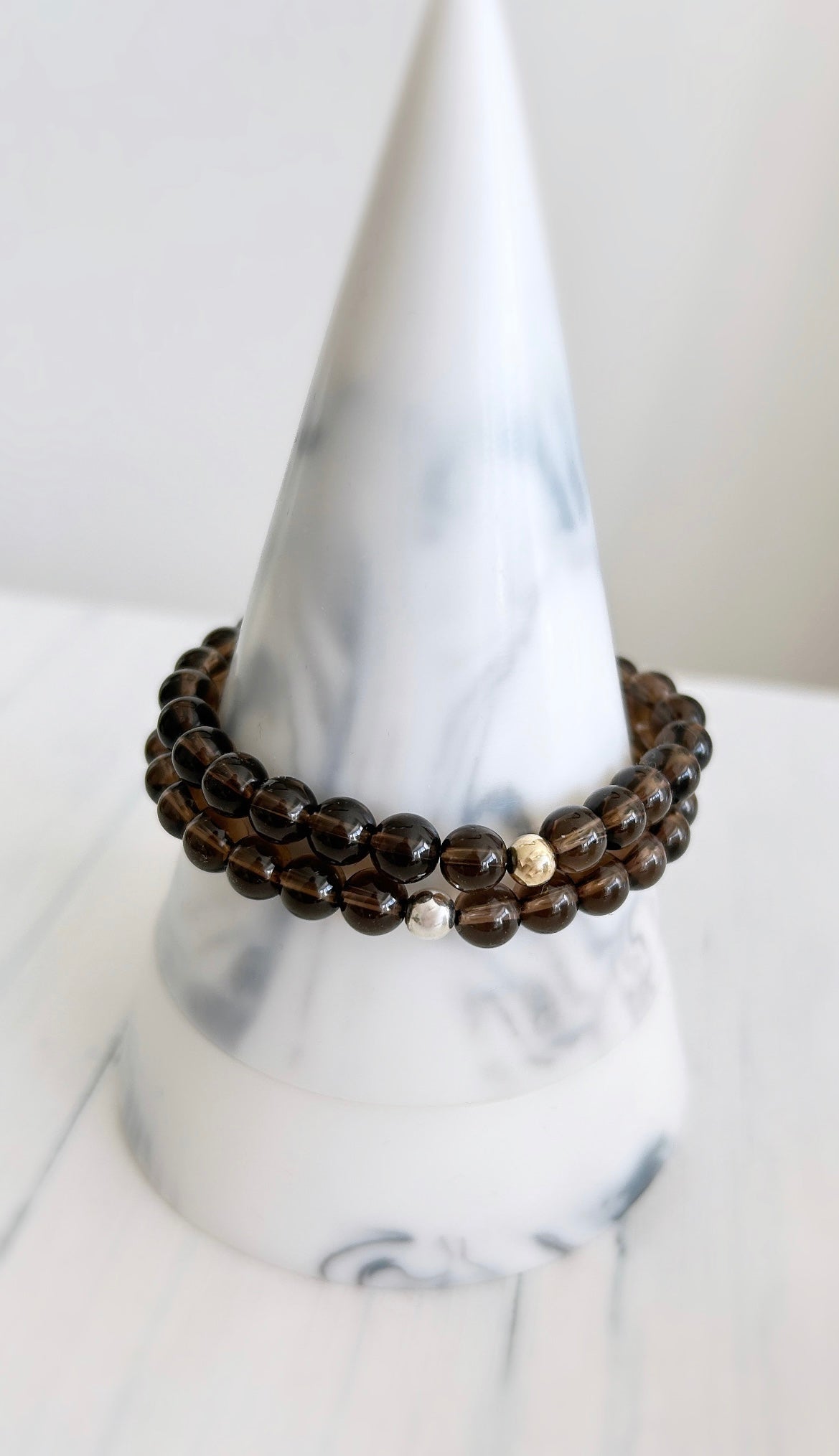 Gorgeous Smoky Quartz beaded bracelet with a Sterling Silver or Gold Filled spacer bead hand threaded on a stretch cord. 