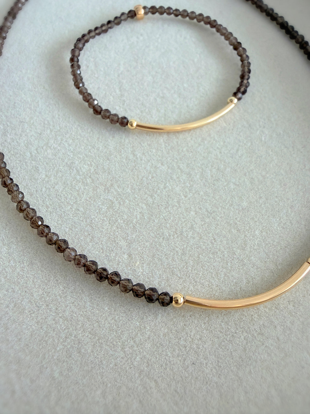 Beautiful Smoky Quartz semi precious faceted bead bracelet hand threaded on a strong stretch elastic cord. This delicate bracelet comes in a choice of two finishes using either Sterling Silver or Gold Filled accents.
