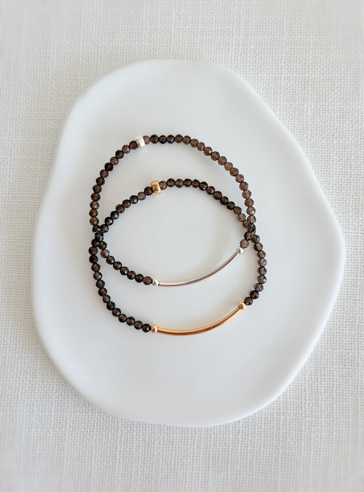 Beautiful Smoky Quartz semi precious faceted bead bracelet hand threaded on a strong stretch elastic cord. This delicate bracelet comes in a choice of two finishes using either Sterling Silver or Gold Filled accents.