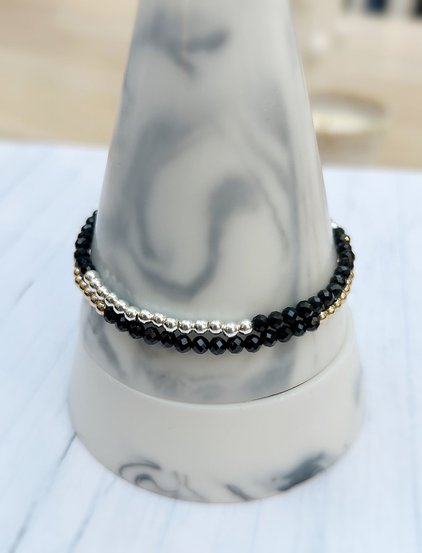 Black Spinel faceted crystal bead bracelet. This delicate bracelet comes in a choice of two finishes using either Sterling Silver or Gold Filled spacer beads and lobster closure clasp.