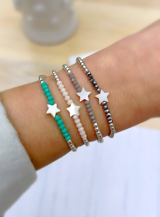 A collection of beaded bracelets with star charms and silver beads 
