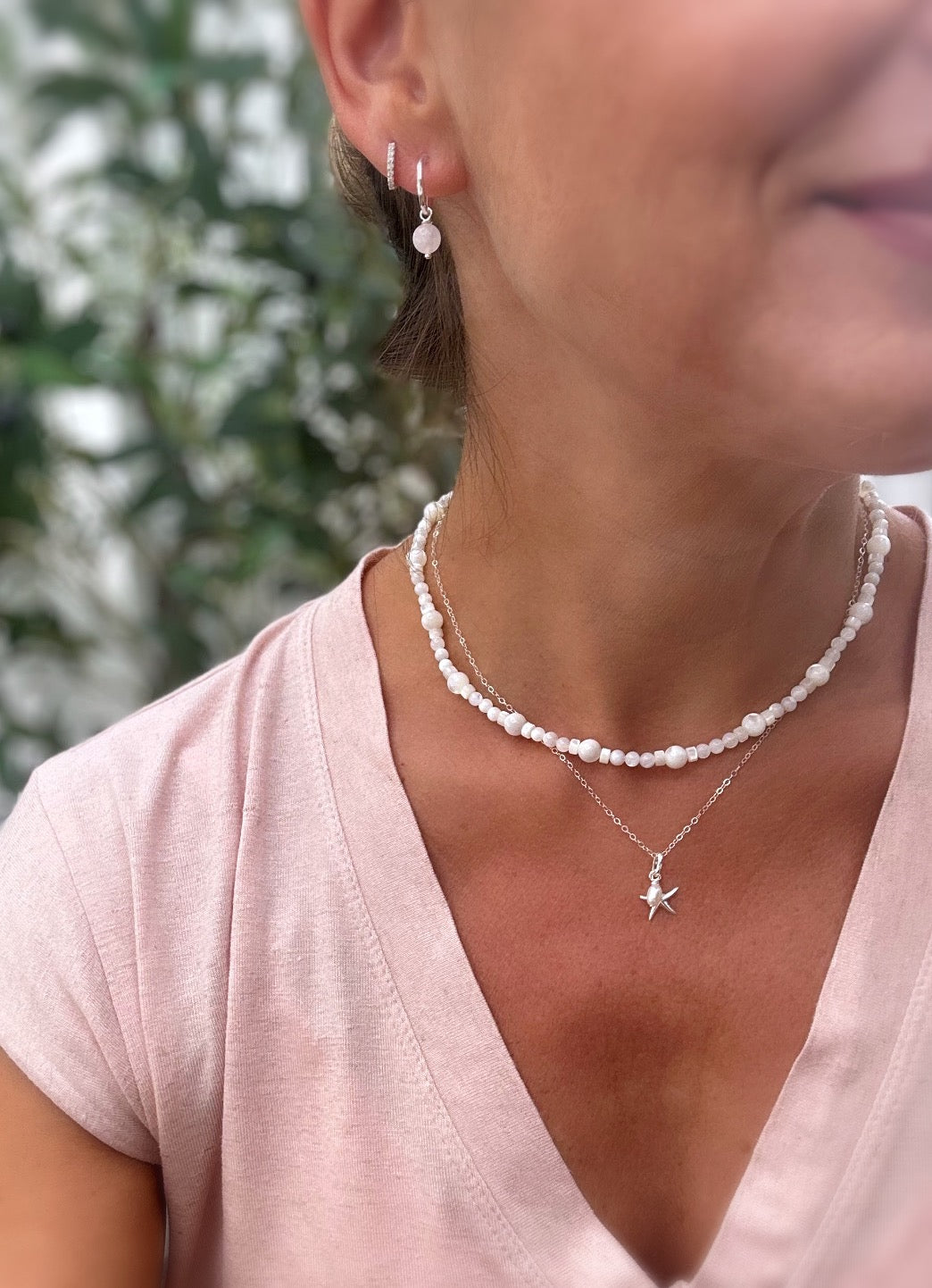 A pretty Silver pendant featuring a Sterling Silver Starfish charm, with a delicate Freshwater Rice Pearl. 