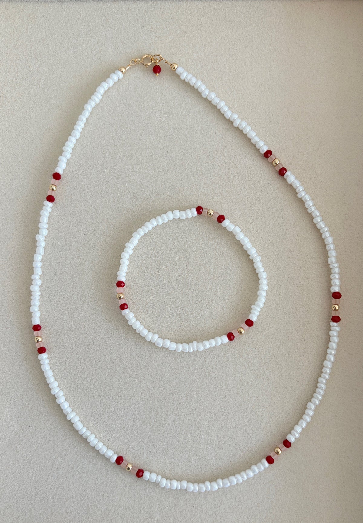 Pretty lustred glass seed bead Necklace, mixed with a subtle pattern of either aqua & pale grey or red/pink crystal glass beads and gold/silver spacer beads. The necklace will be finished with a Gold Filled or Sterling Silver fastening lobster clasp. A perfect necklace for layering with other chains or pendants.
