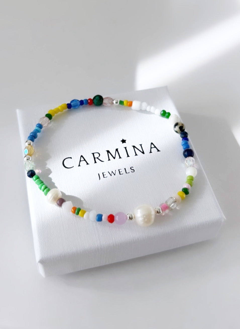 A multicolored beaded bracelet with a mix of pearls and various colored beads
