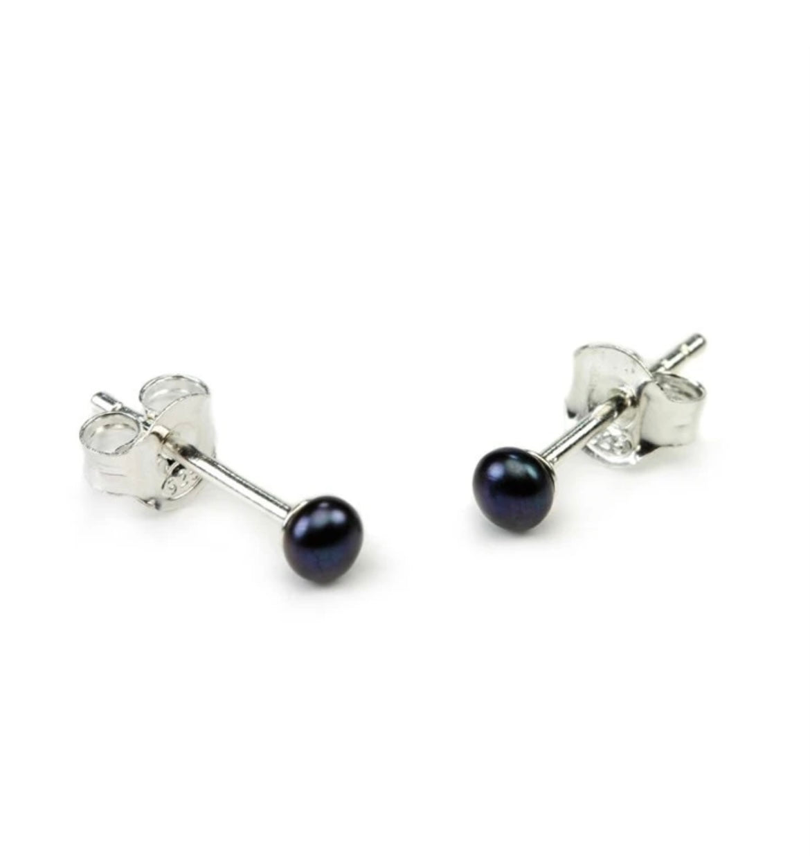A pair of black pearl stud earrings attached to sterling silver posts with butterfly clasps