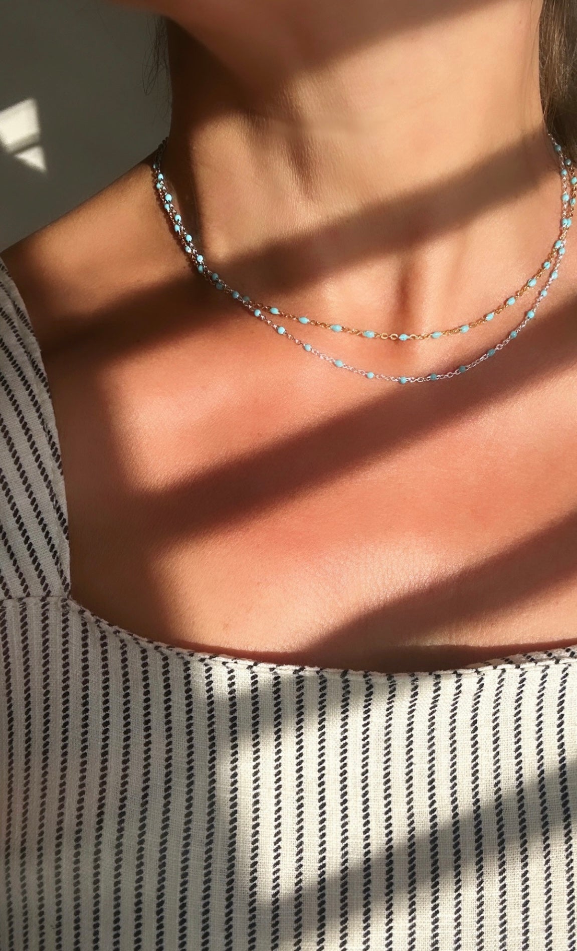 A delicate Gold filled or Sterling Silver flat cable chain necklace dotted with turquoise enamel beads, and finished off with a tiny Amazonite crystal bead at the clasp. 