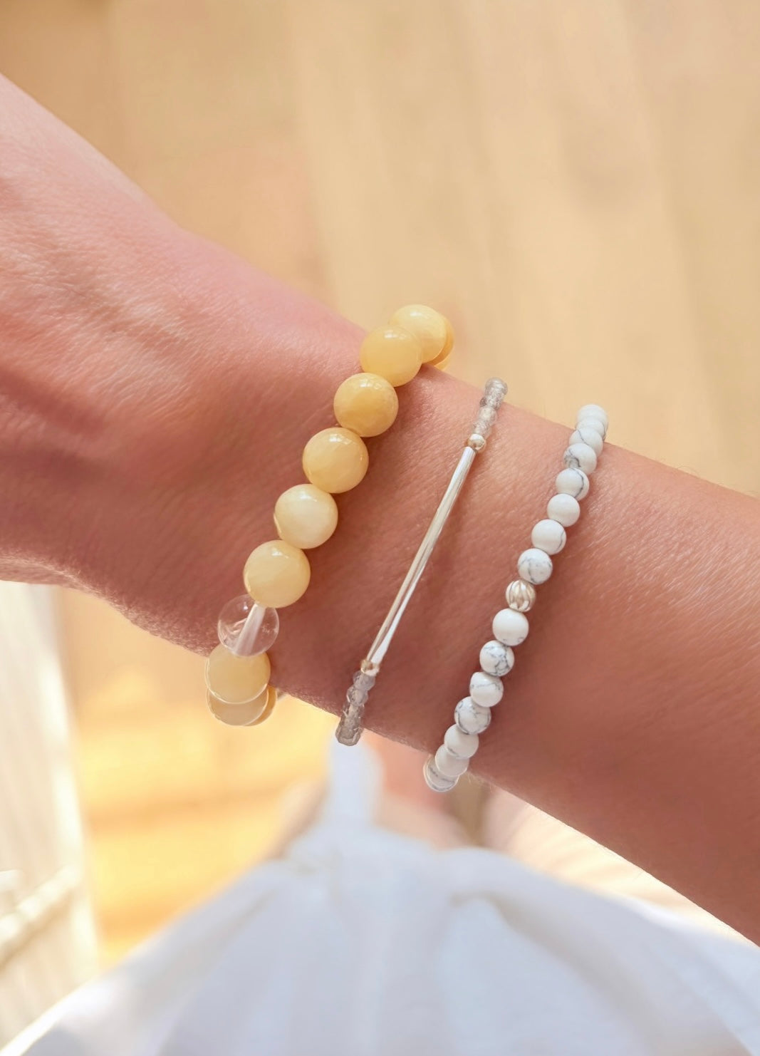 A beautiful semi precious beaded white Howlite stacking bracelet accented with a Sterling Silver twist engraved bead and a Howlite dangle bead, hand threaded on a durable stretch cord.