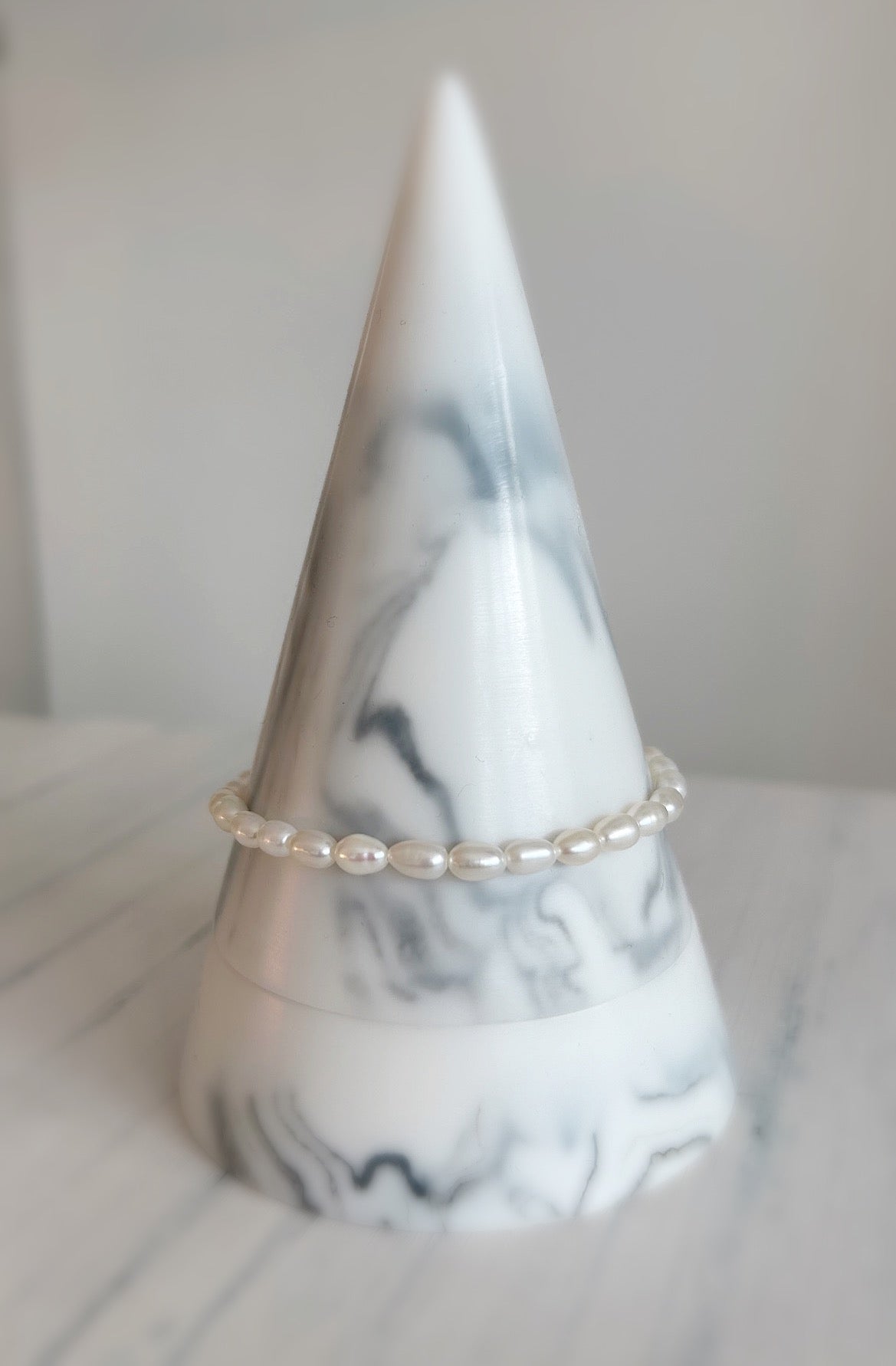 A elegant Freshwater Rice Pearl bracelet finished with a Sterling Silver or Gold Filled lobster clasp, and delicate extension chain with a Pearl at its end