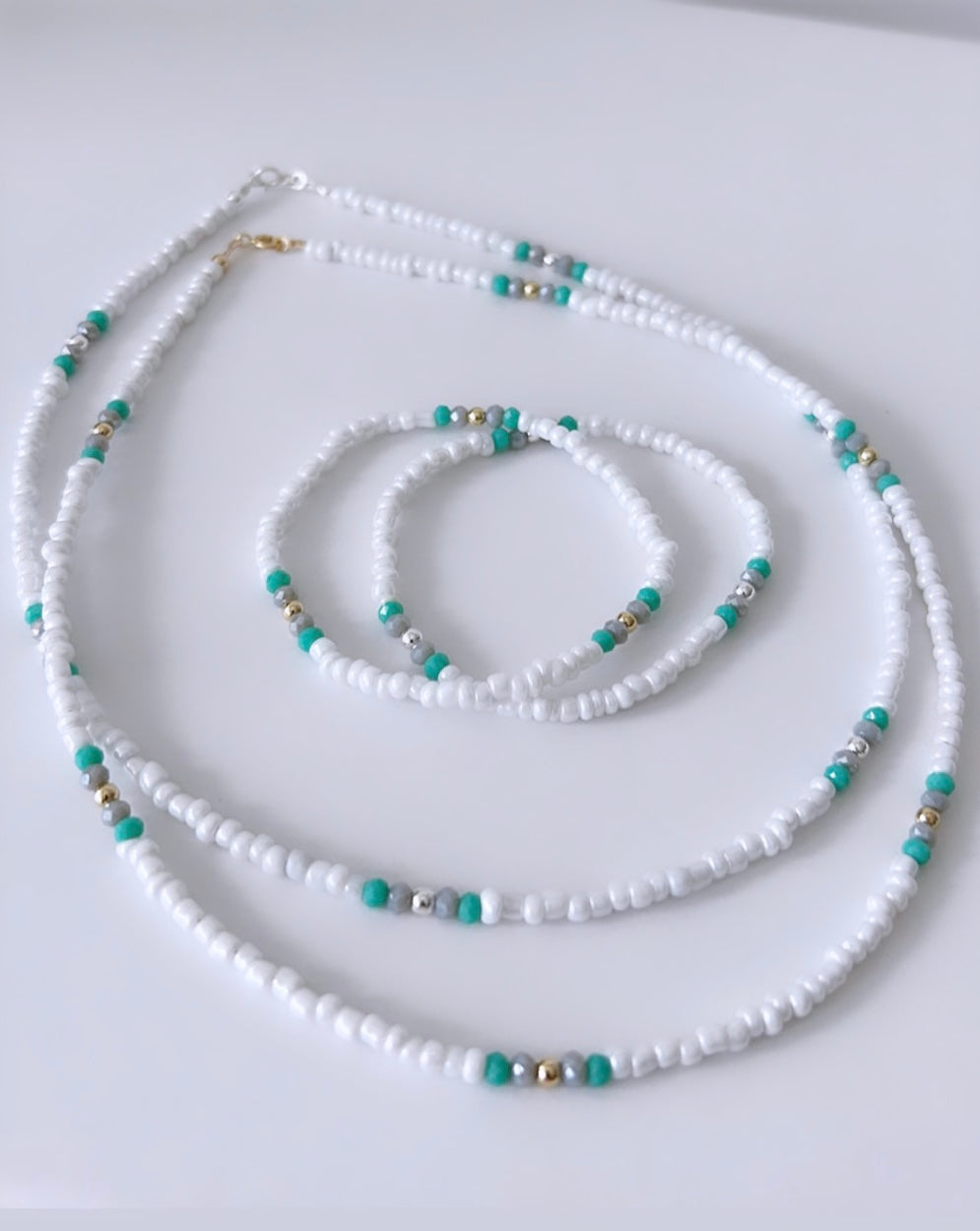 Pretty lustred glass seed bead Necklace, with aqua & pale grey crystal glass beads and gold/silver spacer beads. The necklace will be finished with a Gold Filled or Sterling Silver fastening lobster clasp. A perfect necklace for layering with other chains or pendants.
