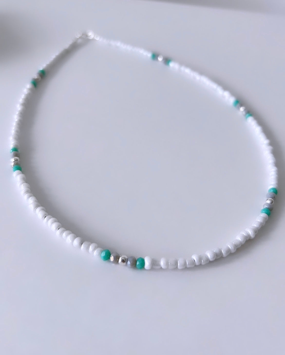 Pretty lustred glass seed bead Necklace, with aqua & pale grey crystal glass beads and gold/silver spacer beads. The necklace will be finished with a Gold Filled or Sterling Silver fastening lobster clasp. A perfect necklace for layering with other chains or pendants.
